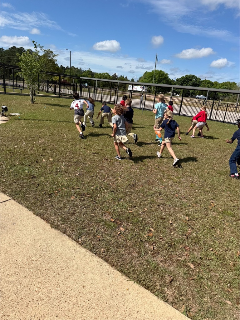 Ms. Weaver's class participated in an outdoor learning activity that included a Math Easter egg hunt. Students collected "eggs" with Three-Digit addition and subtraction equations with regrouping. After collecting, they worked in groups to solve equations on their clipboards.