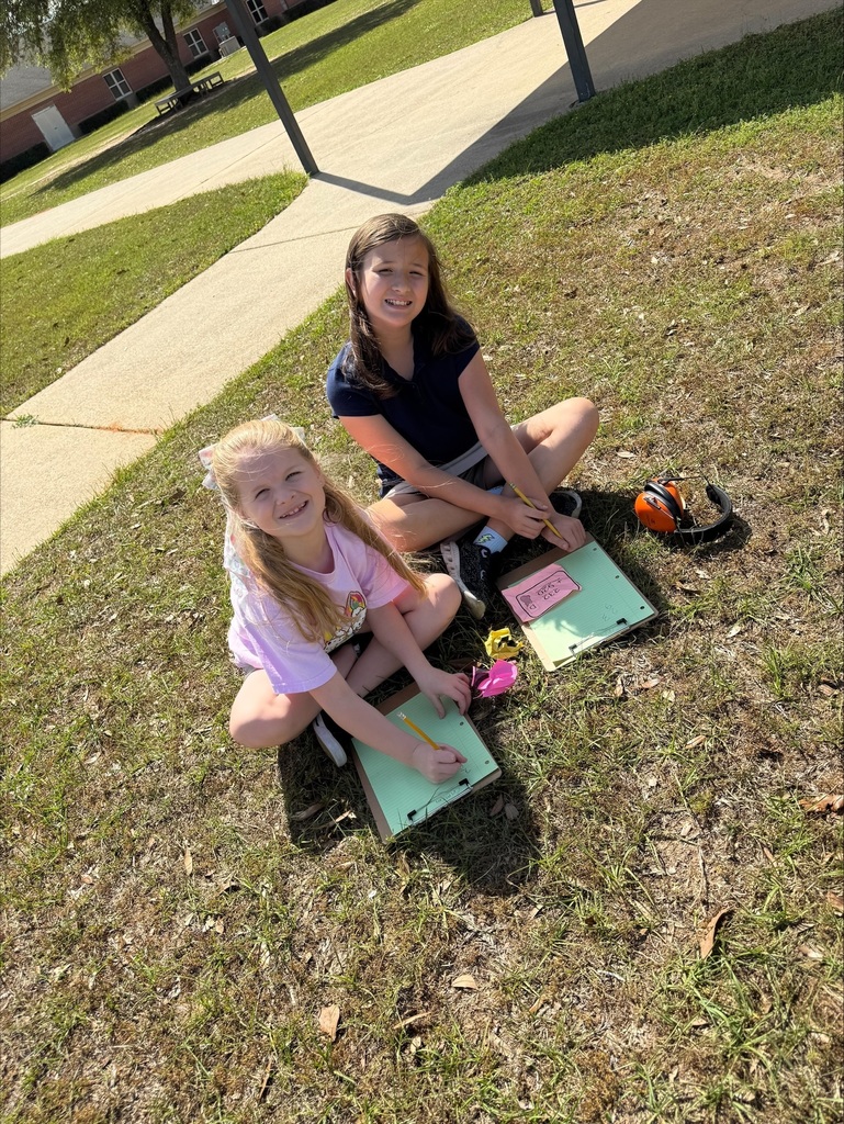 Ms. Weaver's class participated in an outdoor learning activity that included a Math Easter egg hunt. Students collected "eggs" with Three-Digit addition and subtraction equations with regrouping. After collecting, they worked in groups to solve equations on their clipboards.