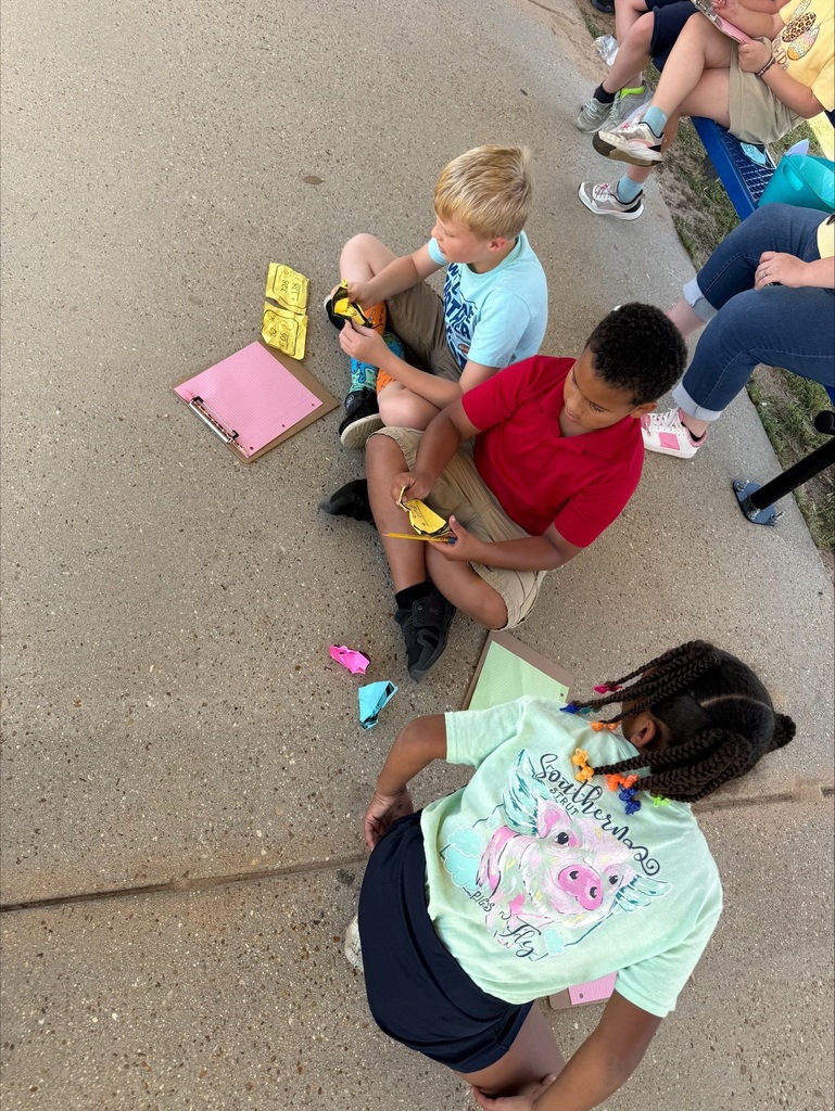 Ms. Weaver's class participated in an outdoor learning activity that included a Math Easter egg hunt. Students collected "eggs" with Three-Digit addition and subtraction equations with regrouping. After collecting, they worked in groups to solve equations on their clipboards.