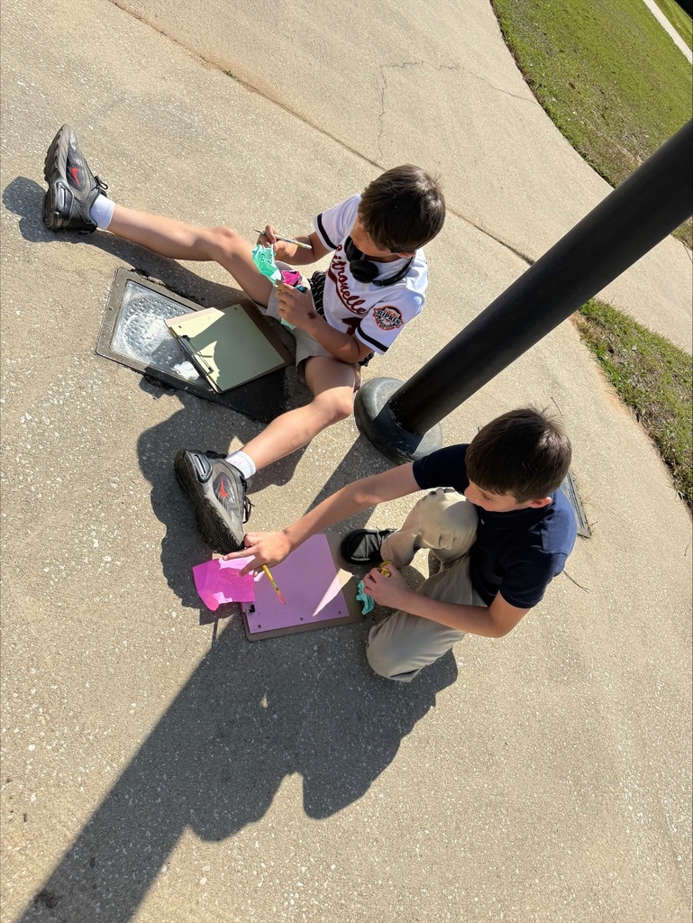 Ms. Weaver's class participated in an outdoor learning activity that included a Math Easter egg hunt. Students collected "eggs" with Three-Digit addition and subtraction equations with regrouping. After collecting, they worked in groups to solve equations on their clipboards.