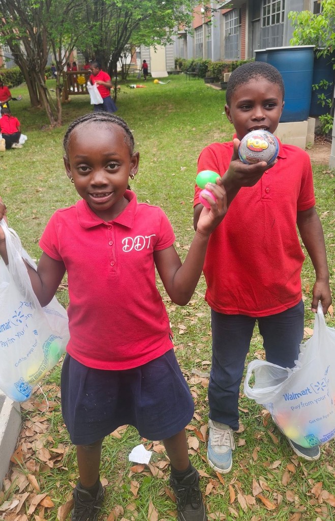 Two George Hall students show the Easter eggs they found