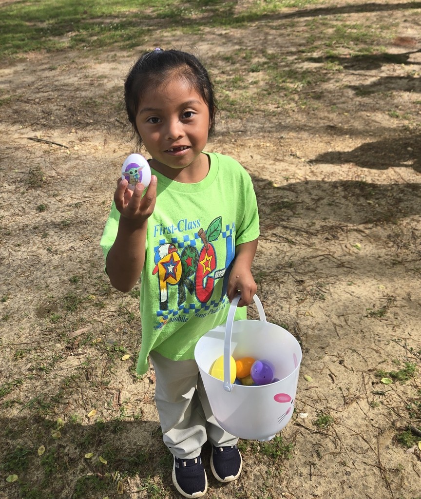 A Mary Montgomery Pre-K student holds an egg and a basket