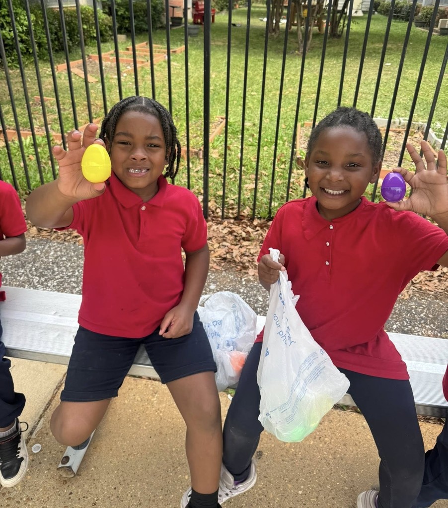 Two George Hall students hold up the eggs they found