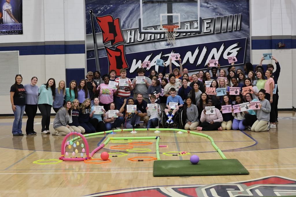 A group of Alma Bryant High students holding certificates in the school's gym