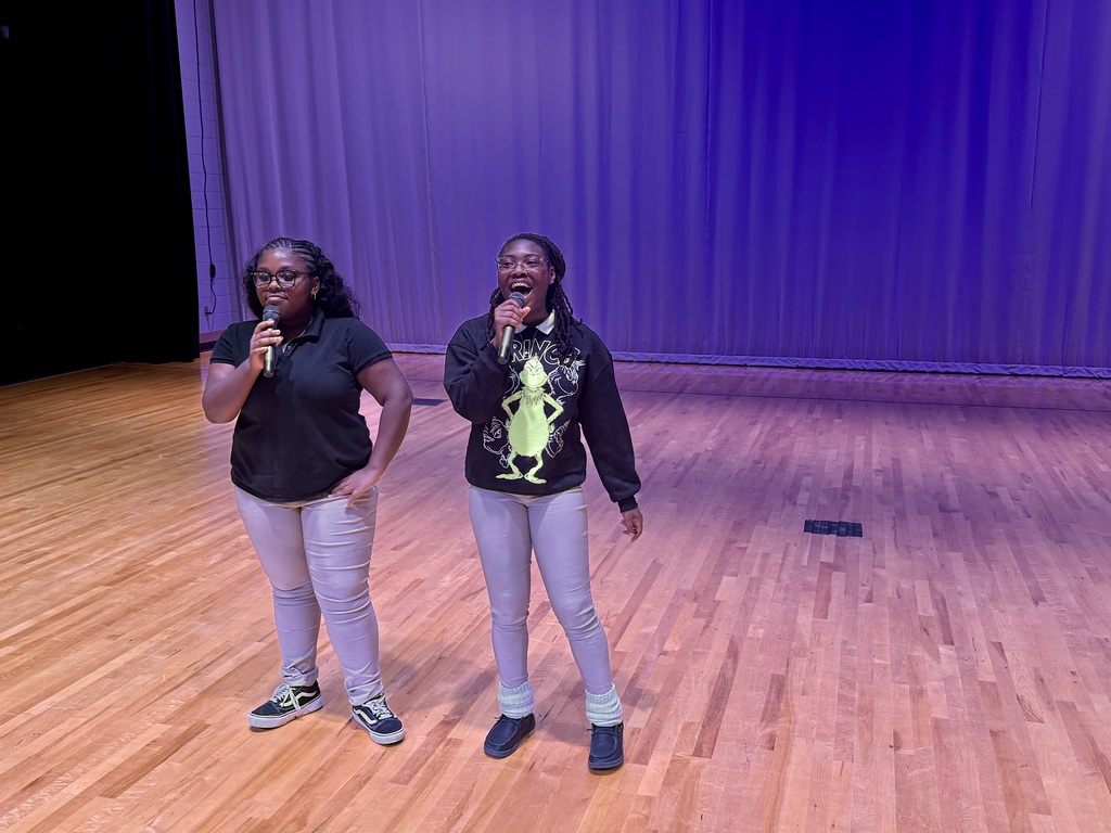 Two female students singing together during the talent show.