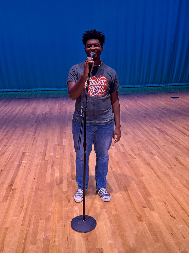 A male student singing during the talent show. 