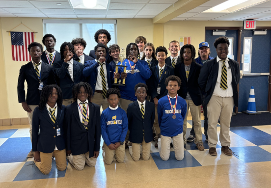 Phillips boys track team, wearing medals and holding a trophy