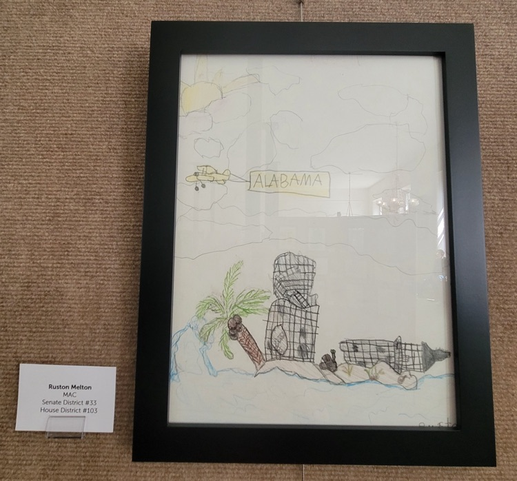 Ruston‘s artwork showing a broken lighthouse on a beach with an airplane flying an Alabama banner