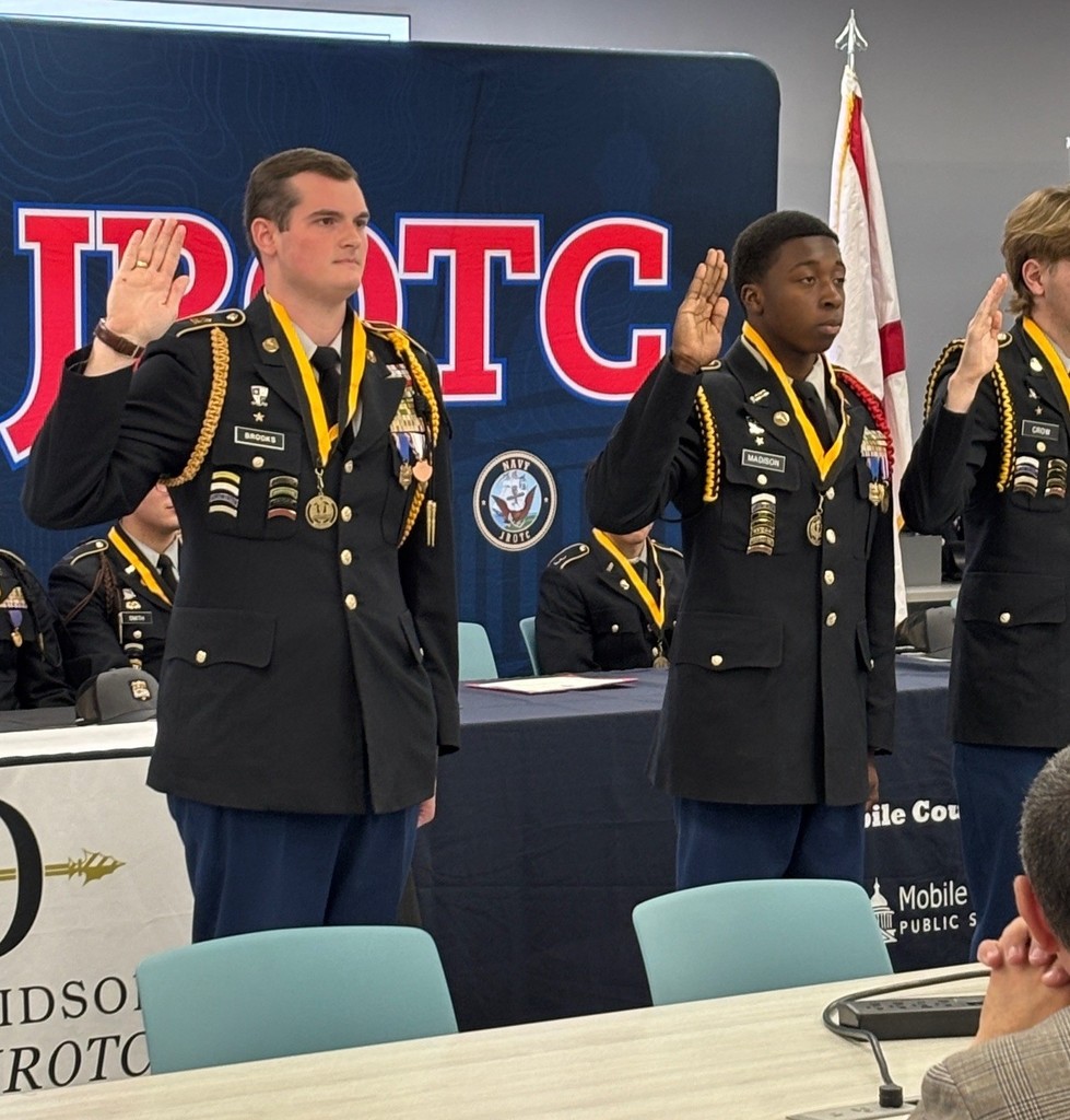 JROTC cadets raising their hands to take an oath