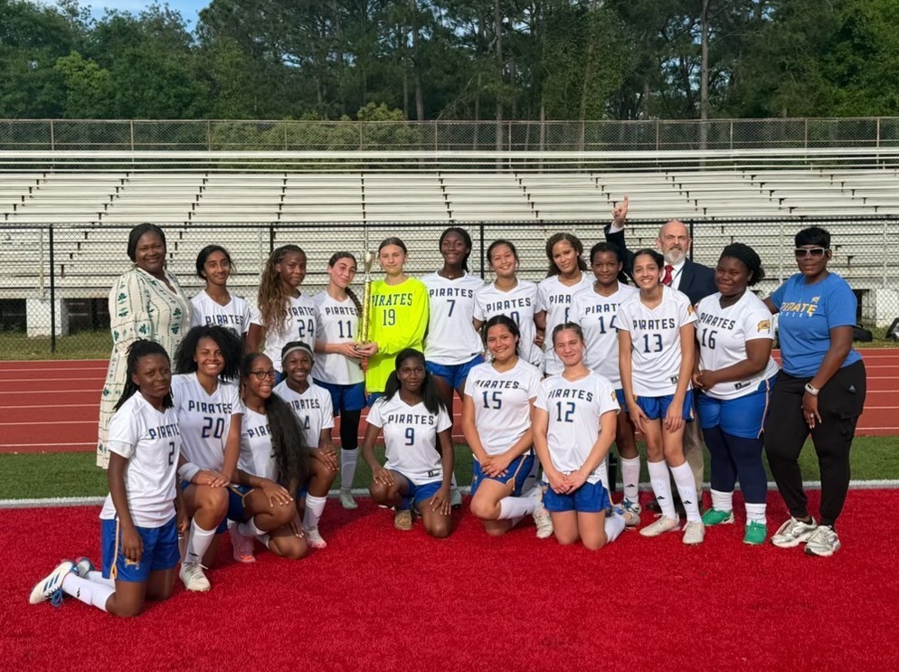 The Phillips Preparatory girls soccer team, with its trophy