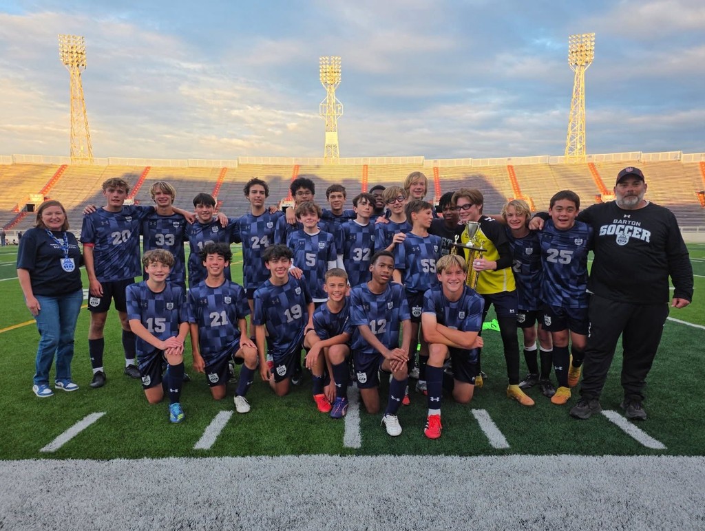 The Barton Academy boys soccer team, with its trophy