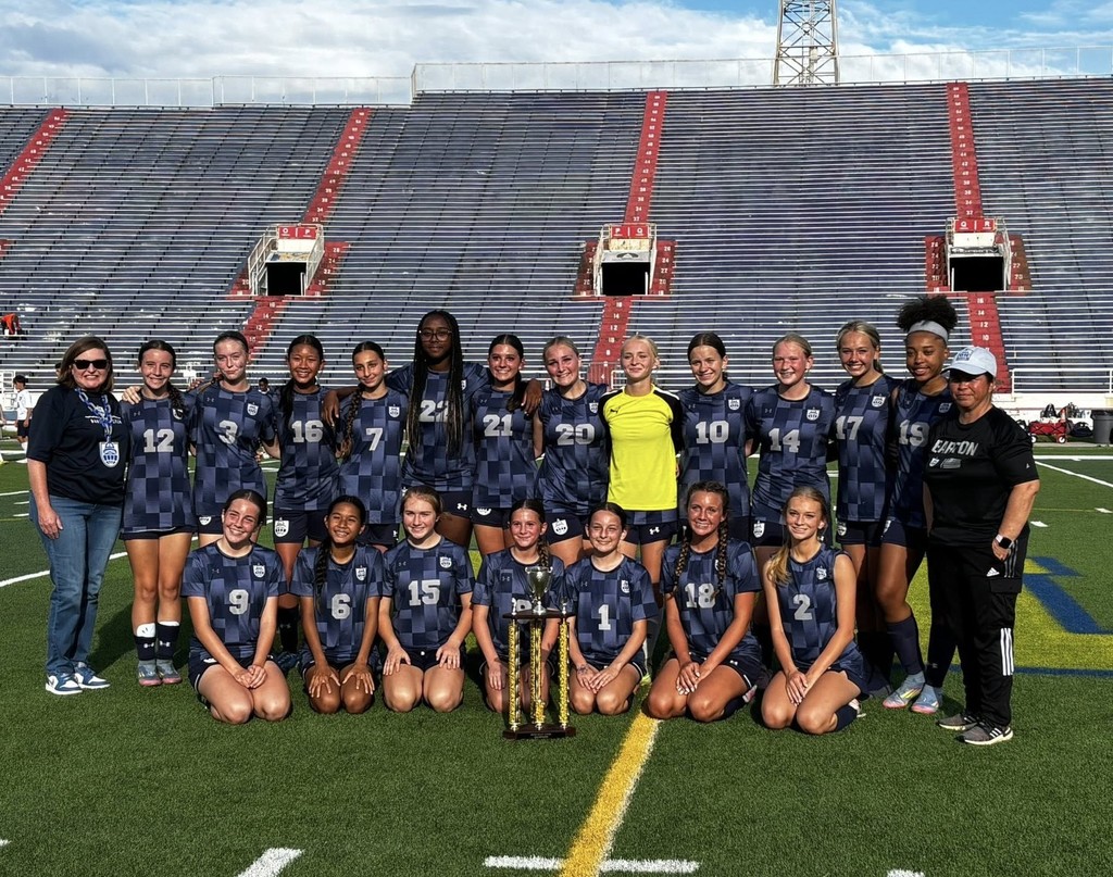 The Barton Academy girls soccer team, with its trophy