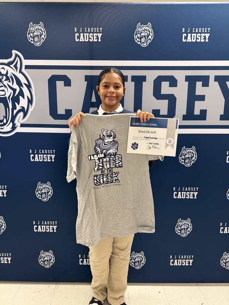 Student holding t-shirt and certificate