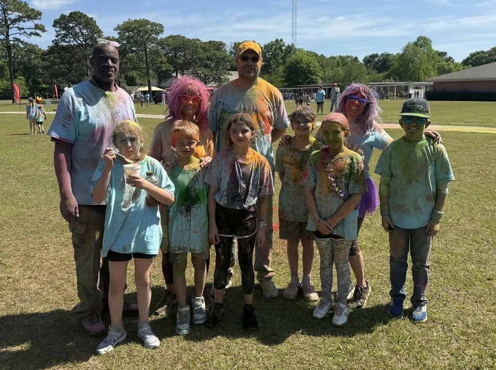 Several Hollinger's Island students and teachers with colorful chalk all over them