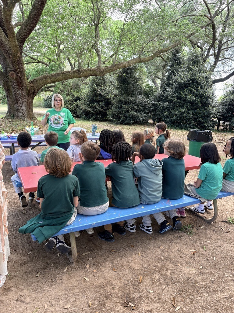 Meadowlake students sitting at picnic tables outside to learn about pollinators.