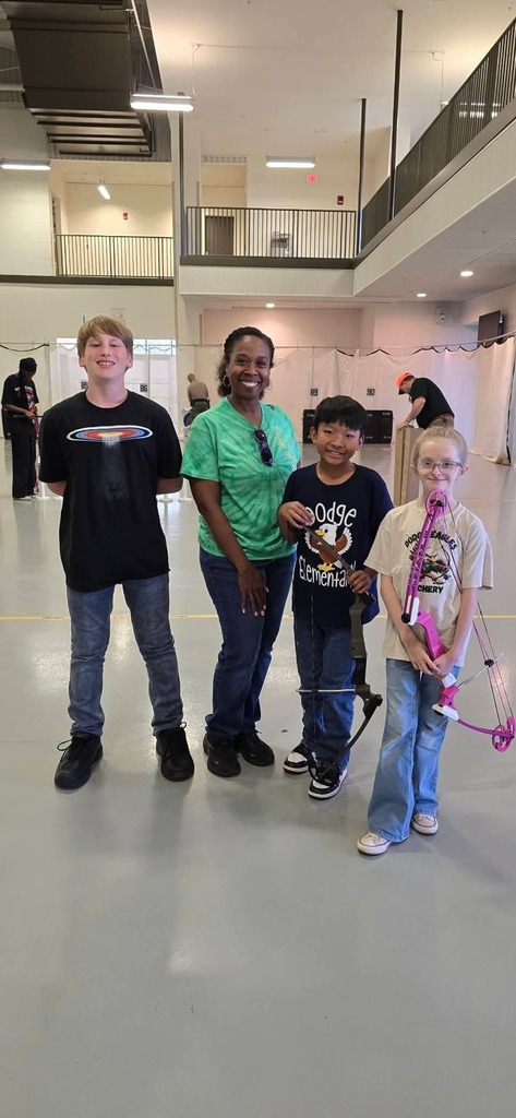 3 archery students and 1 archery coach at the state bullseye competition