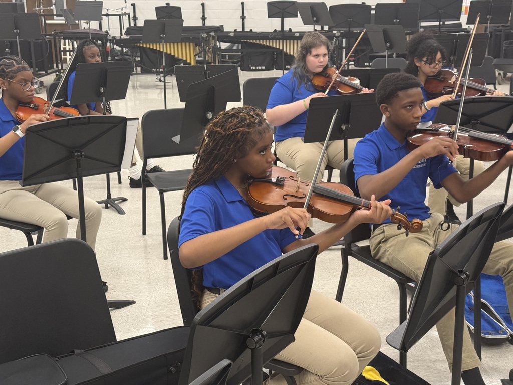 Ensemble members warming up in the THS band room before making their way to the stage.