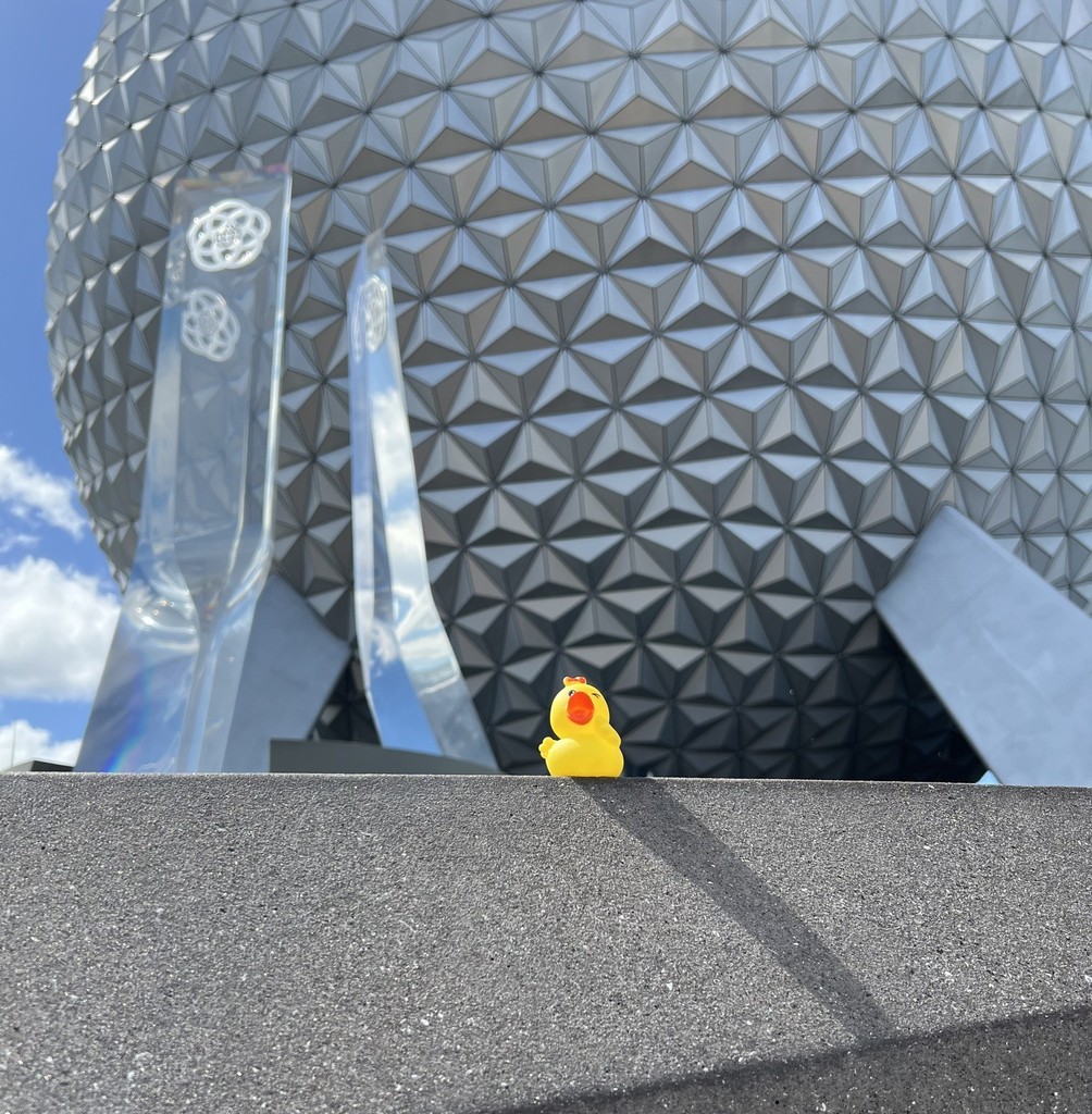 A rubber duck on a wall in front of the sphere at Epcot