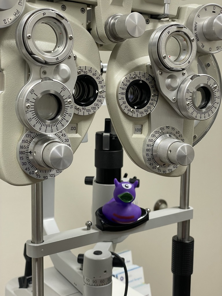A rubber duck sitting on an eye examination machine