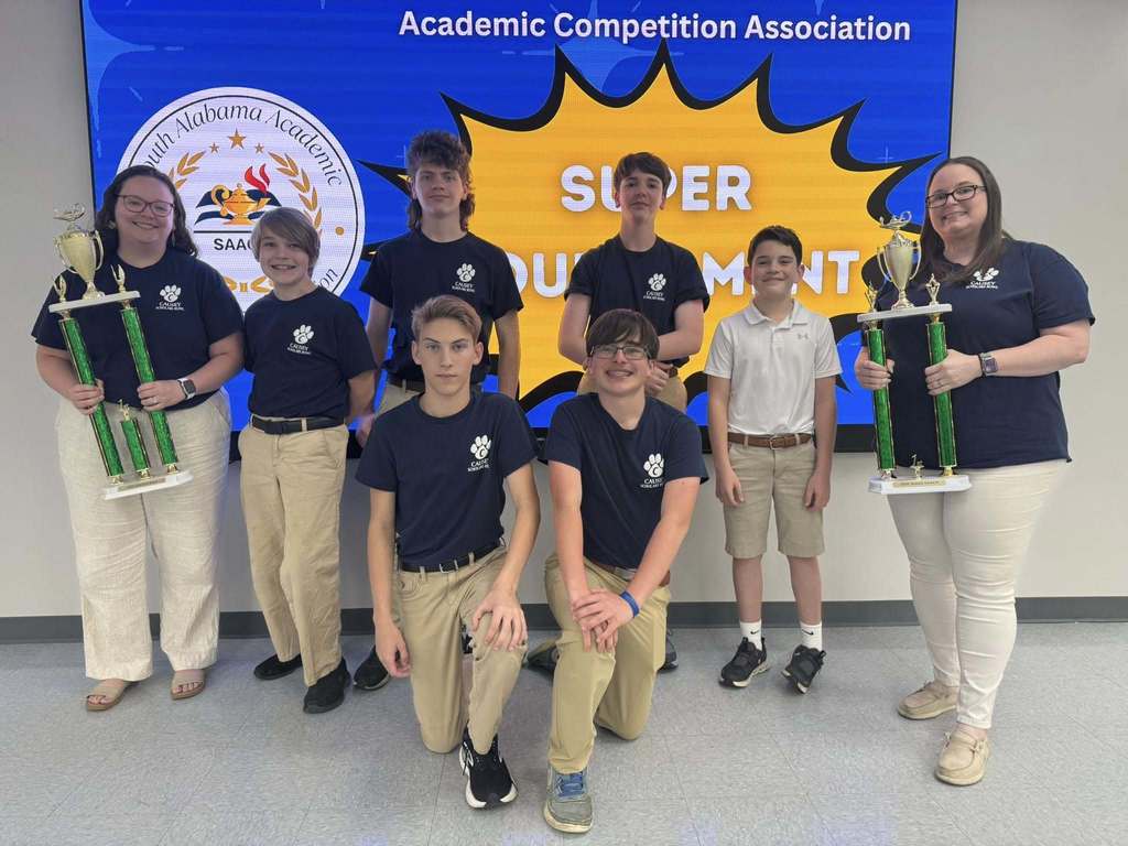 Causey Middle School students holding two trophies