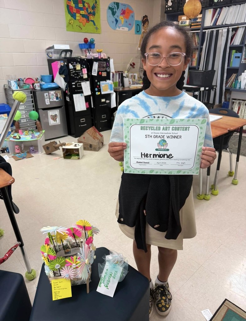 A girl holding a certificate, with a toy made of paper umbrellas