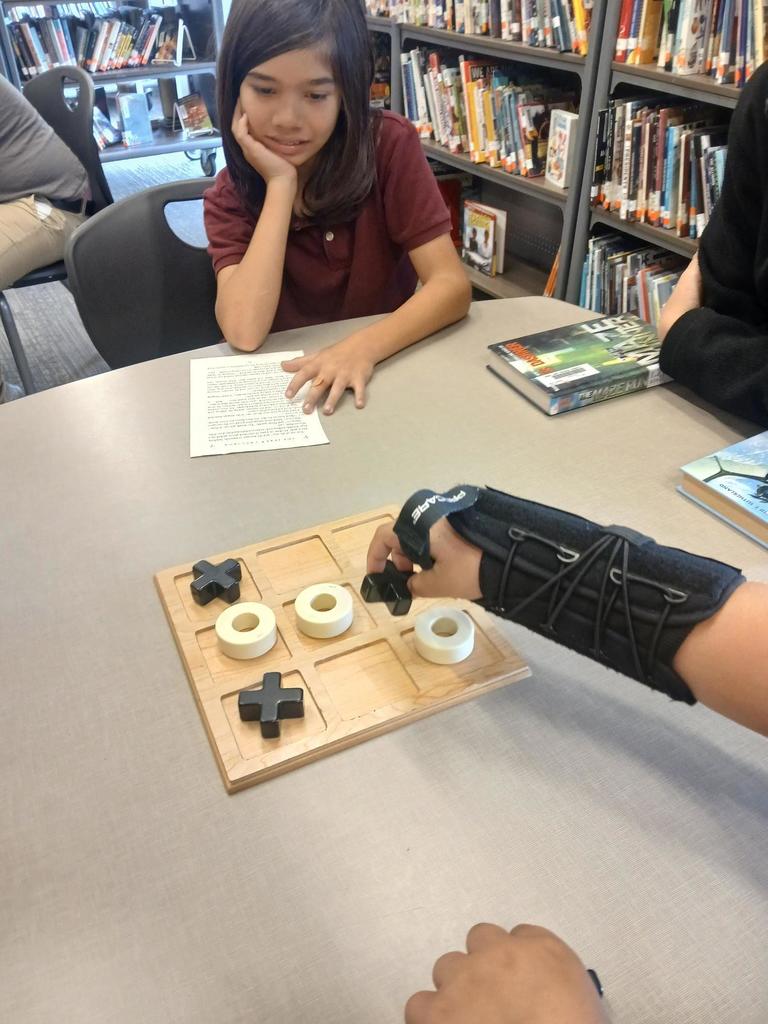 Students playing tic tac toe