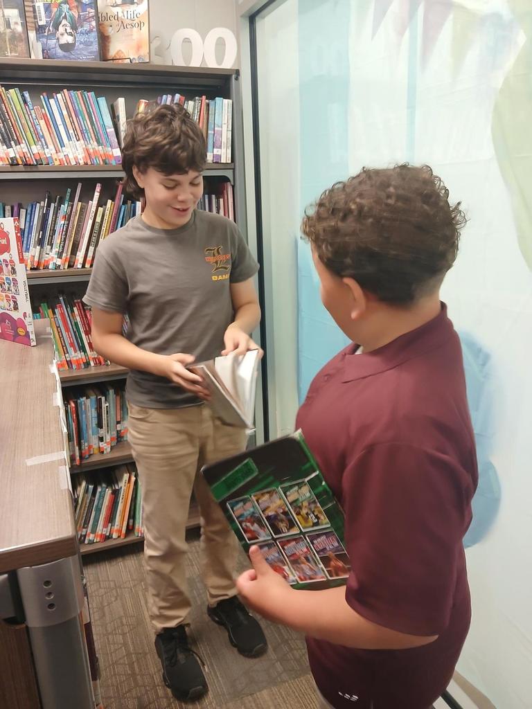 Boys picking out new books