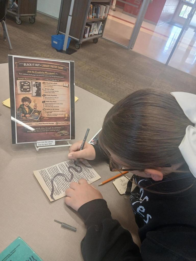 Student starting a blackout poem