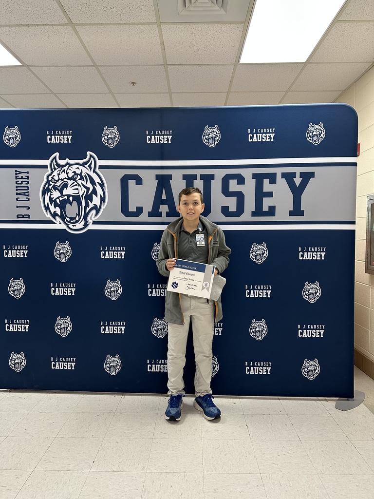 Student holding t-shirt and certificate