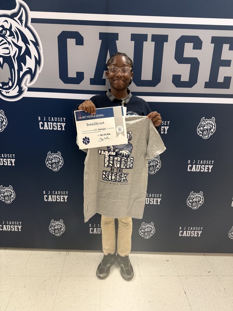 Student holding t-shirt and certificate