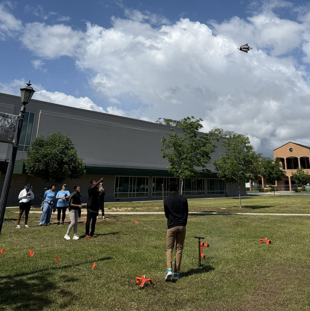 Students watching a water bottle rocket fly
