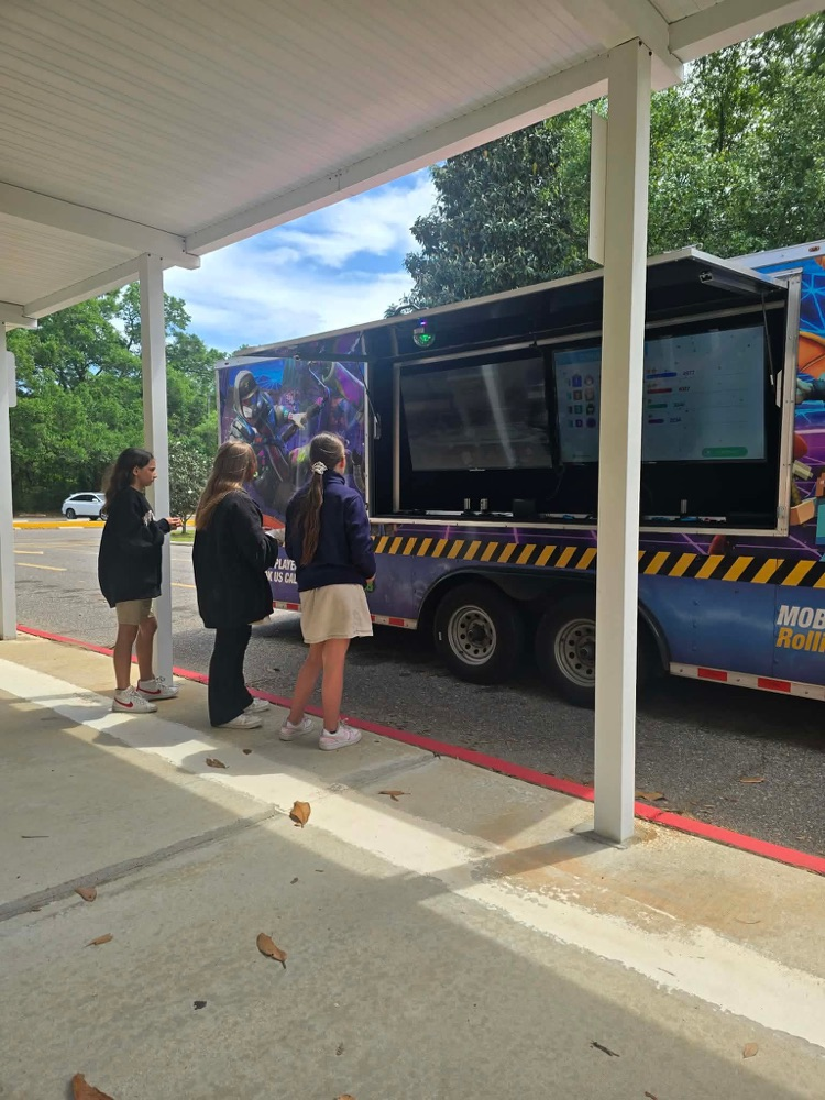 2nd-5th grade students playing on the game truck