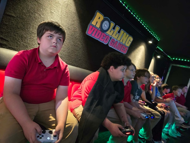 2nd-5th grade students playing on the game truck