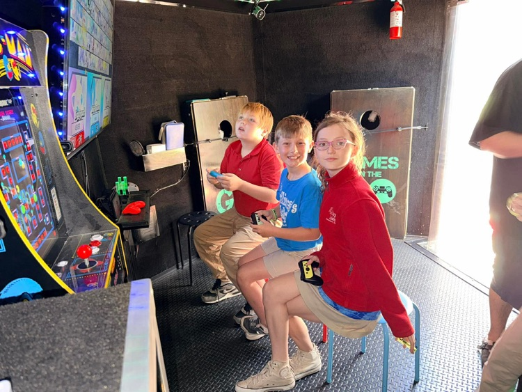 2nd-5th grade students playing on the game truck