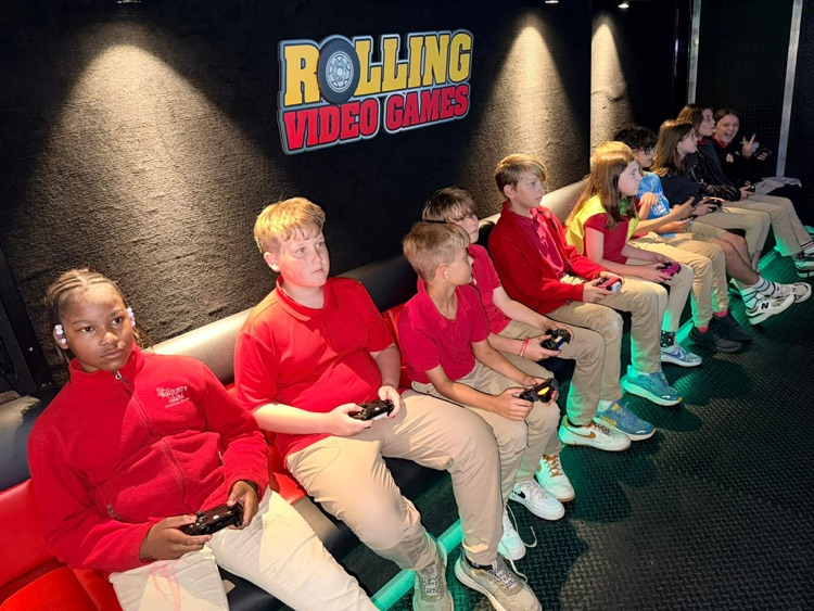 2nd-5th grade students playing on the game truck