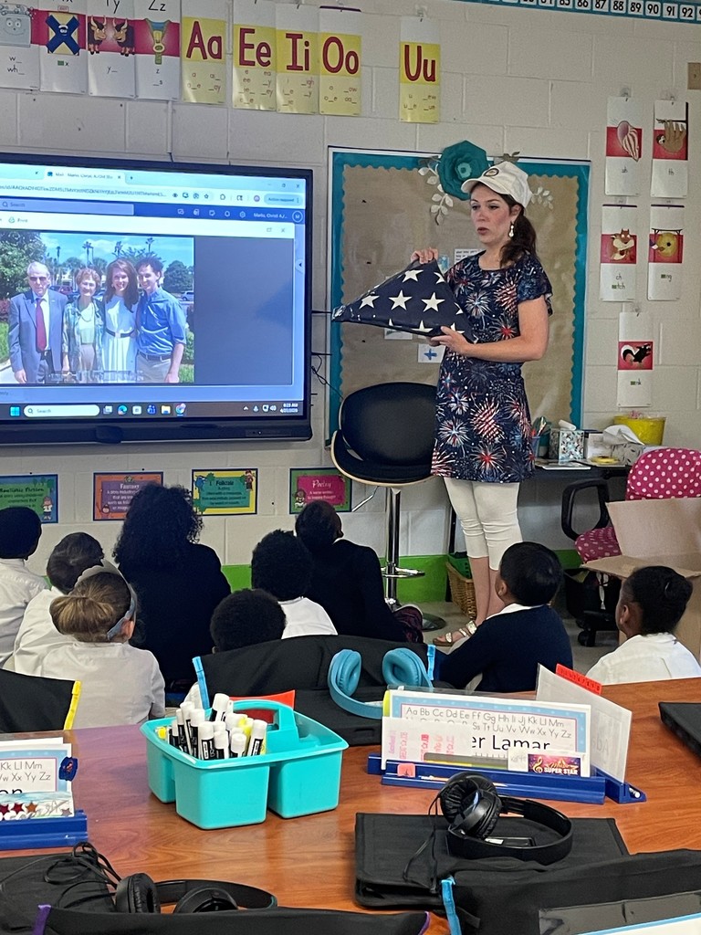 Pictures of first graders during the discussion about a student's great grandfather earning a Purple Heart in WWII.