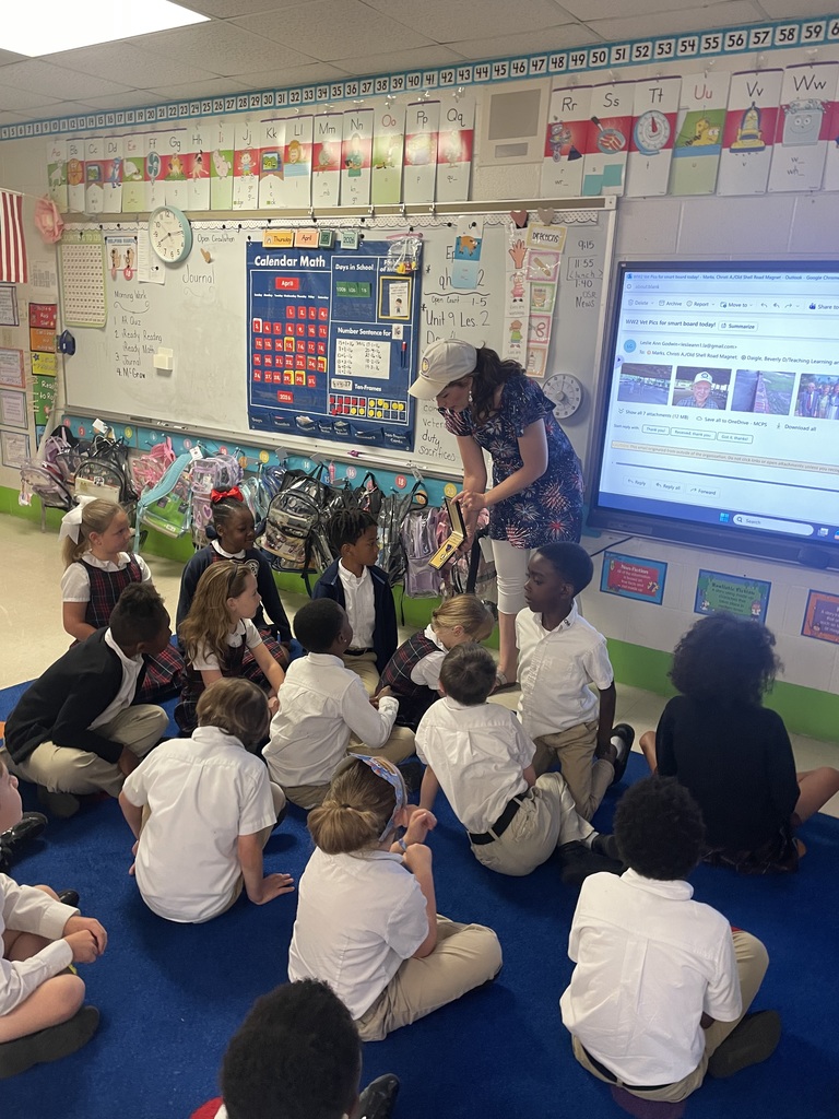 Pictures of first graders during the discussion about a student's great grandfather earning a Purple Heart in WWII.