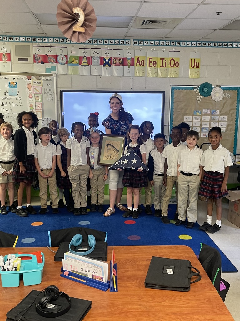 Pictures of first graders during the discussion about a student's great grandfather earning a Purple Heart in WWII.