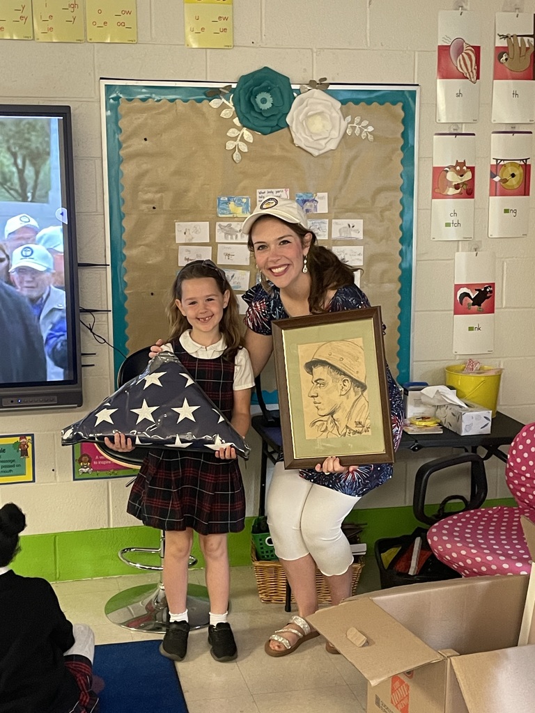Pictures of first graders during the discussion about a student's great grandfather earning a Purple Heart in WWII.
