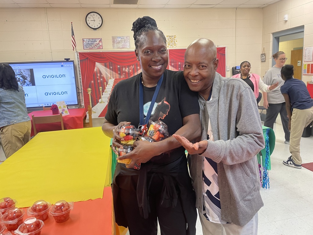 teachers holding fruit cups they received during teacher appreciation week 