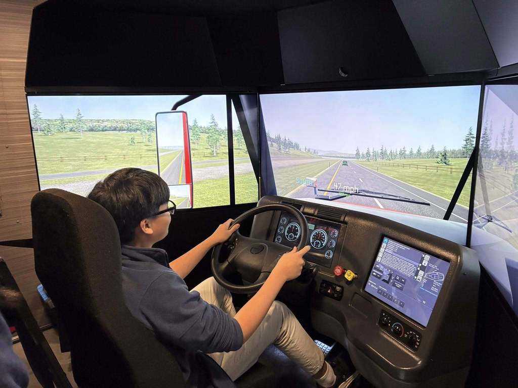 A student driving a truck simulator. 