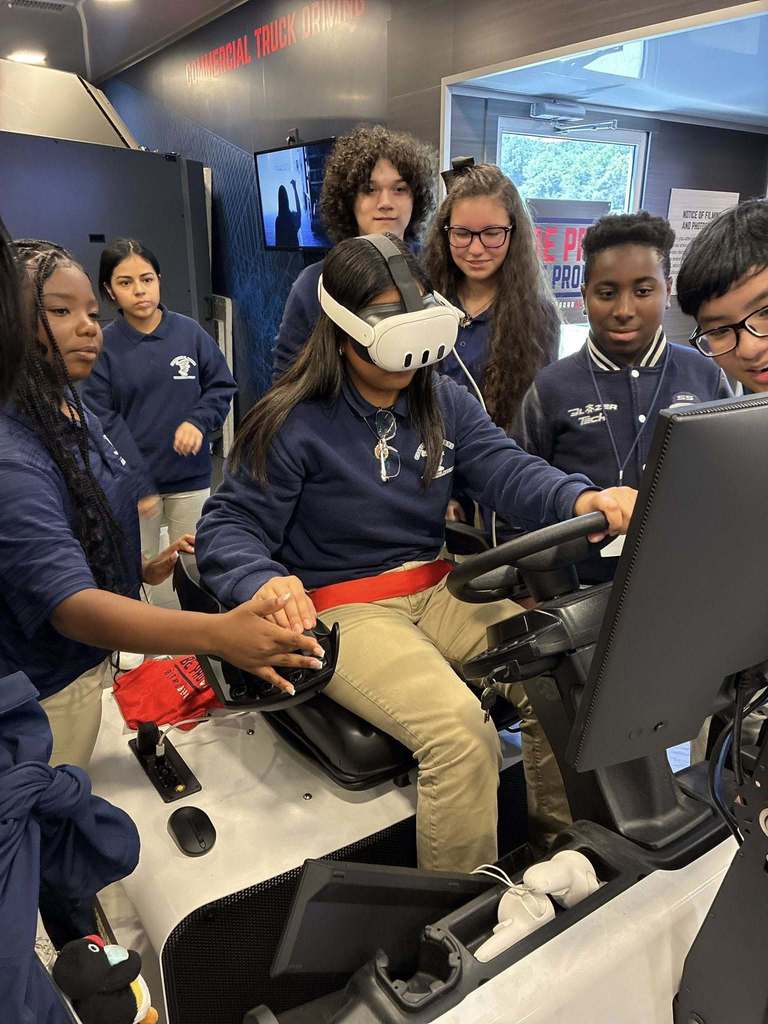 A group of students exploring a machinery virtual simulator. 