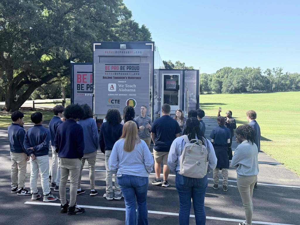 A group of students standing in front of the Be Pro Be Proud Alabama truck.