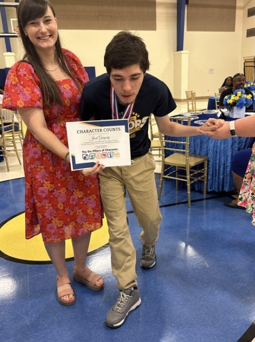 JG with school counselor receiving an award 
