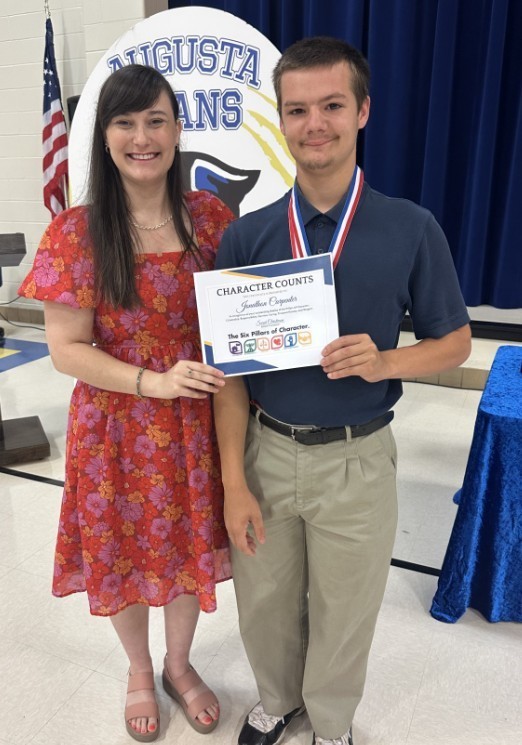 JC receiving an ward from school counselor 