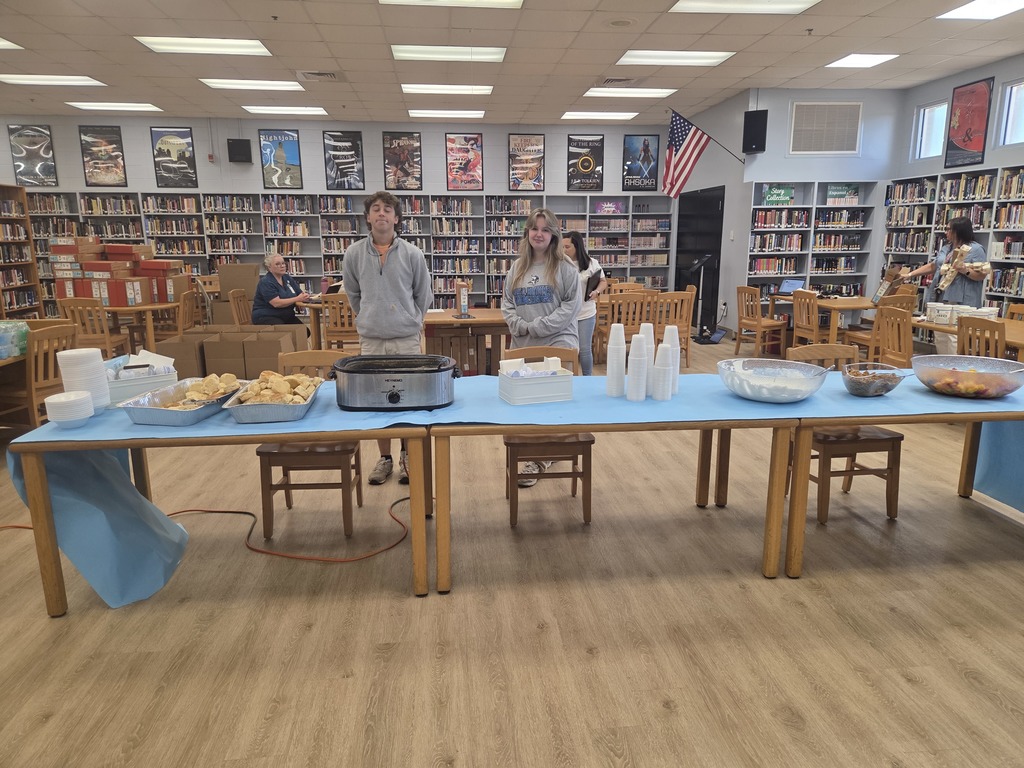 Students standing at table with food