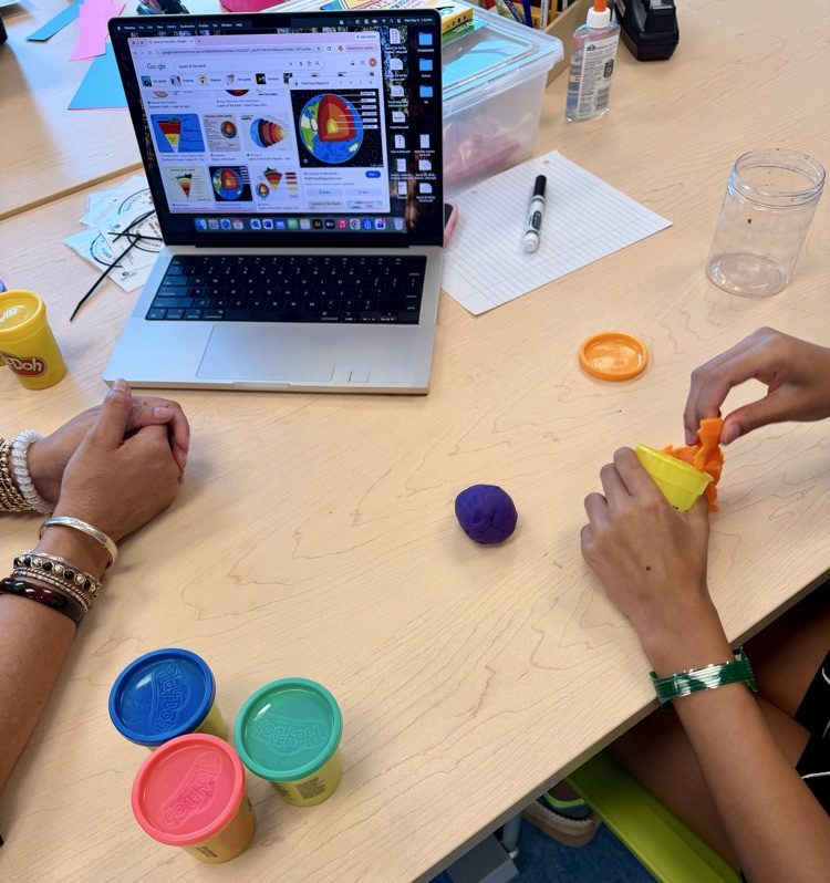 student hands with modeling clay