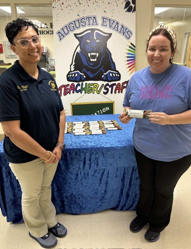 Mrs. Kidd with a cub level teacher passing out the Hershey bar for day 3 of teacher appreciation 