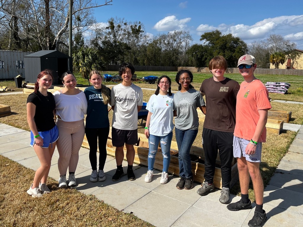 A group of high school students standing outside