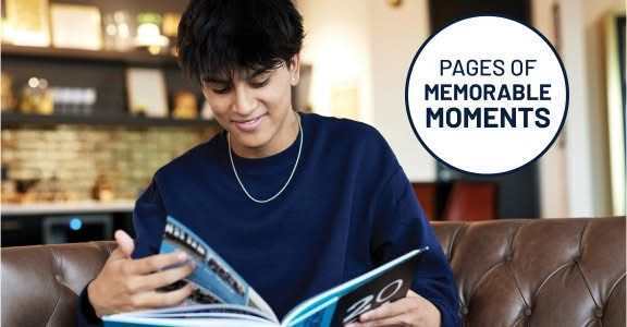 Student looking at a yearbook.